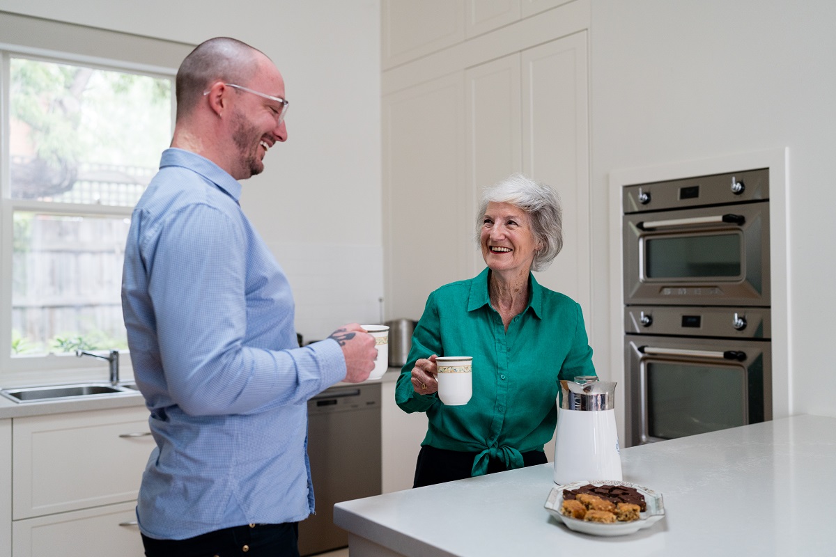 An AccessCare client and case manager have a cup of coffee together