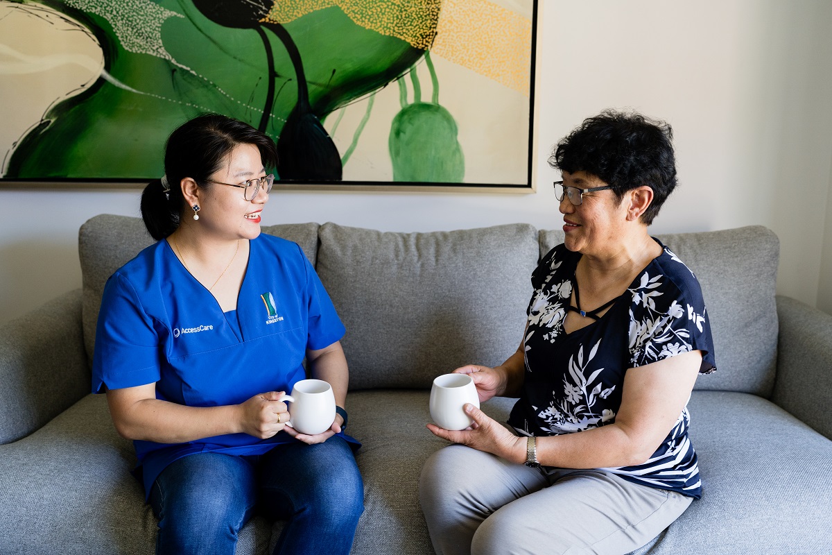 AccessCare support worker sits and chats with a client.